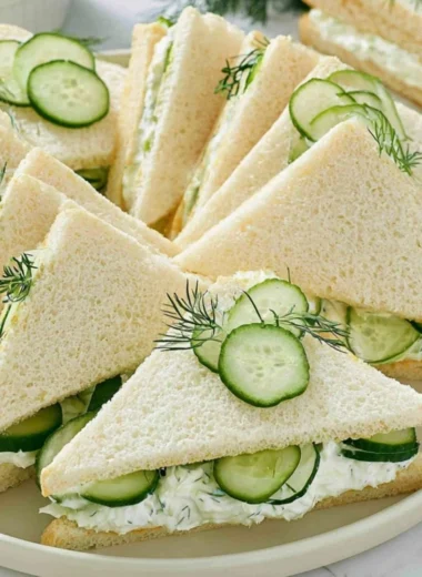 Delicious cucumber sandwiches served with fresh ingredients and sides.