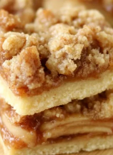 Delicious Apple Crisp Shortbread Bars on a wooden table.