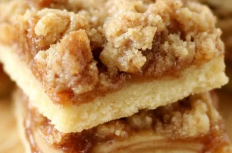 Delicious Apple Crisp Shortbread Bars on a wooden table.