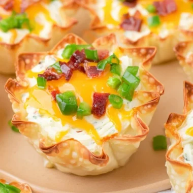 Cozy jalapeño popper wonton cups filled with creamy cheese and spicy jalapeños.