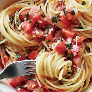 Cozy pasta served with fresh tomato sauce and basil
