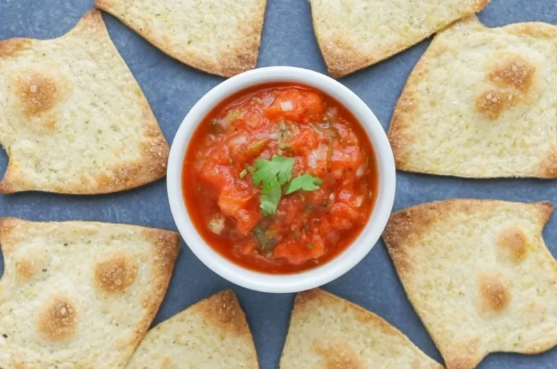 A bowl of baked Halloween chips in spooky shapes, ideal for festive snacking.