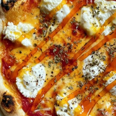 Slice of hot honey ricotta pizza drizzled with honey