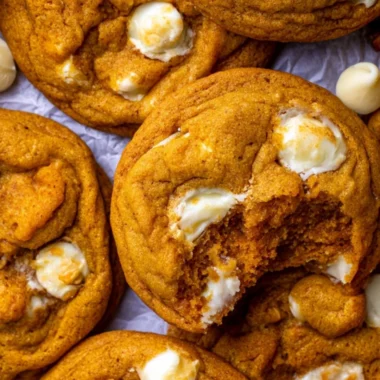 Freshly baked pumpkin white chocolate chip cookies on a rustic wooden table