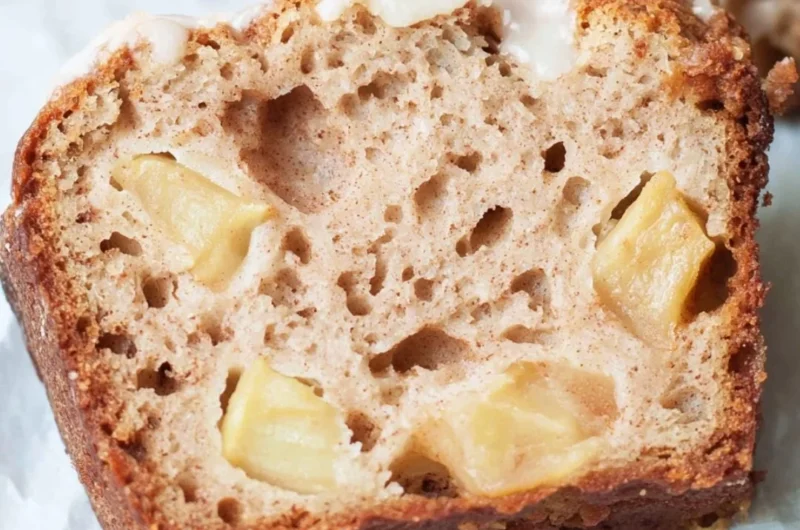 Freshly baked sourdough apple bread with chunks of apple and a golden crust.