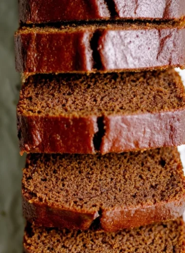 Delicious classic gingerbread loaf cake on a rustic wooden table