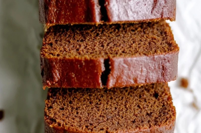 Delicious classic gingerbread loaf cake on a rustic wooden table
