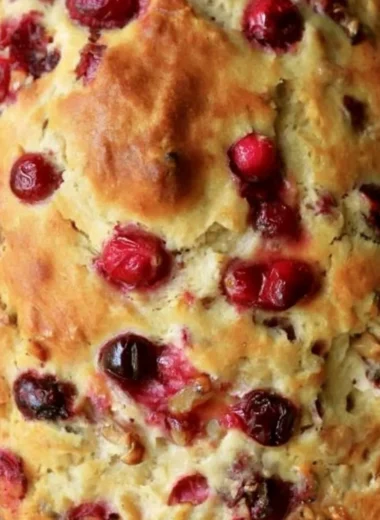 Loaf of Mom's delicious homemade cranberry walnut bread with nuts and berries.