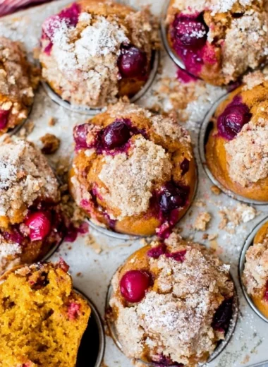 Freshly baked Pumpkin Spice Cranberry Muffins with warm spices and cranberries